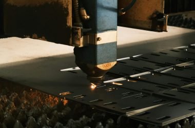 Close-up of a laser cutter in action, showcasing modern industrial technology.